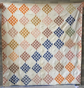 An early patchwork quilt in a Flying Geese variation, circa mid to late 19th century. Some brown