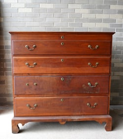 A New England 2 drawer blanket chest in butternut having 2 false drawers over 2 drawers on replaced