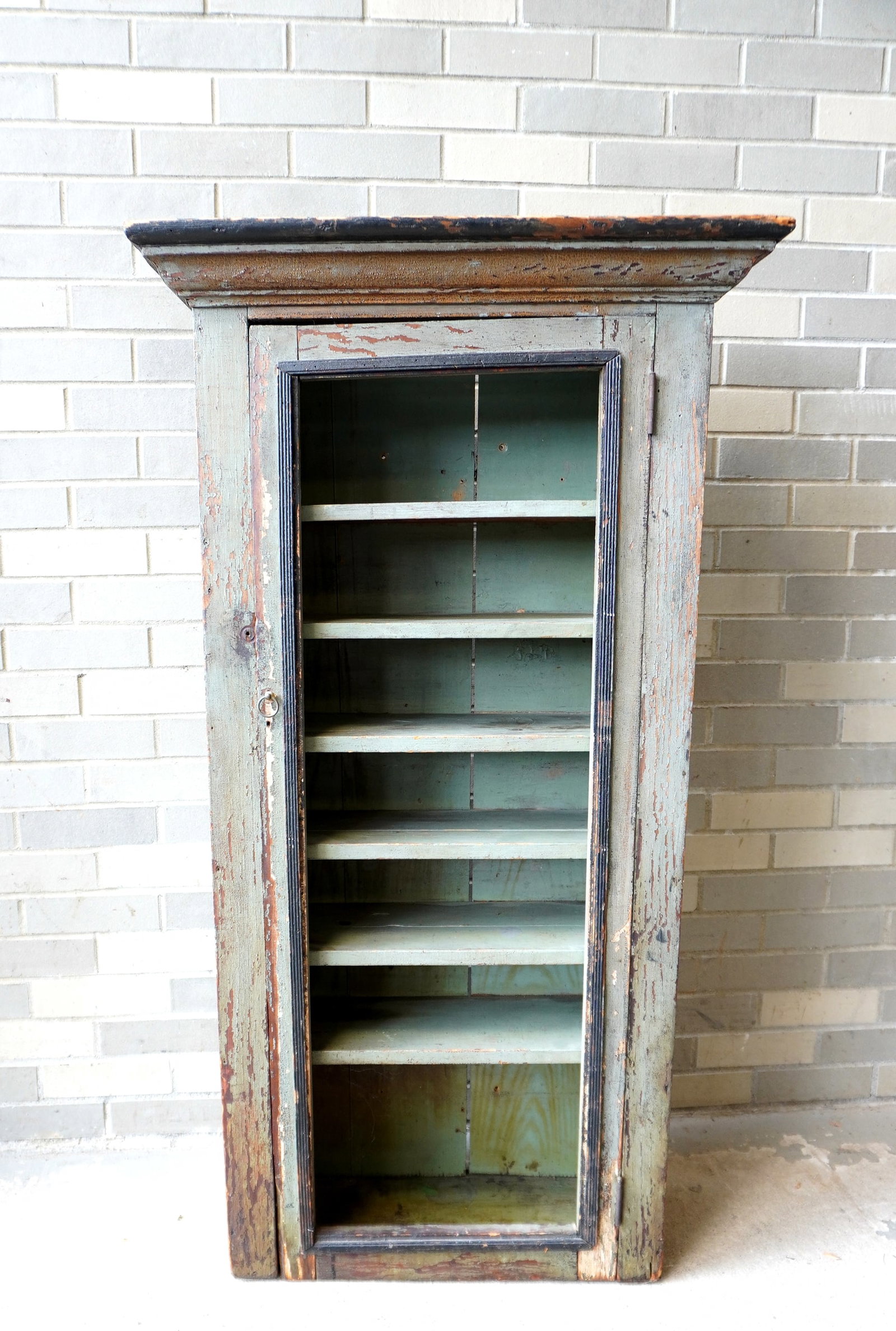 A single door kitchen cupboard in original green paint with stencils of grapes and leaves on side: A single door kitchen cupboard in original green paint with stencils of grapes and leaves on side panels and original stepped cornice - missing screen on door. Probably for storing baked goods or fres