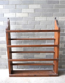 An early pine wall mounted plate rack, early 19th century with hand forged iron brackets for