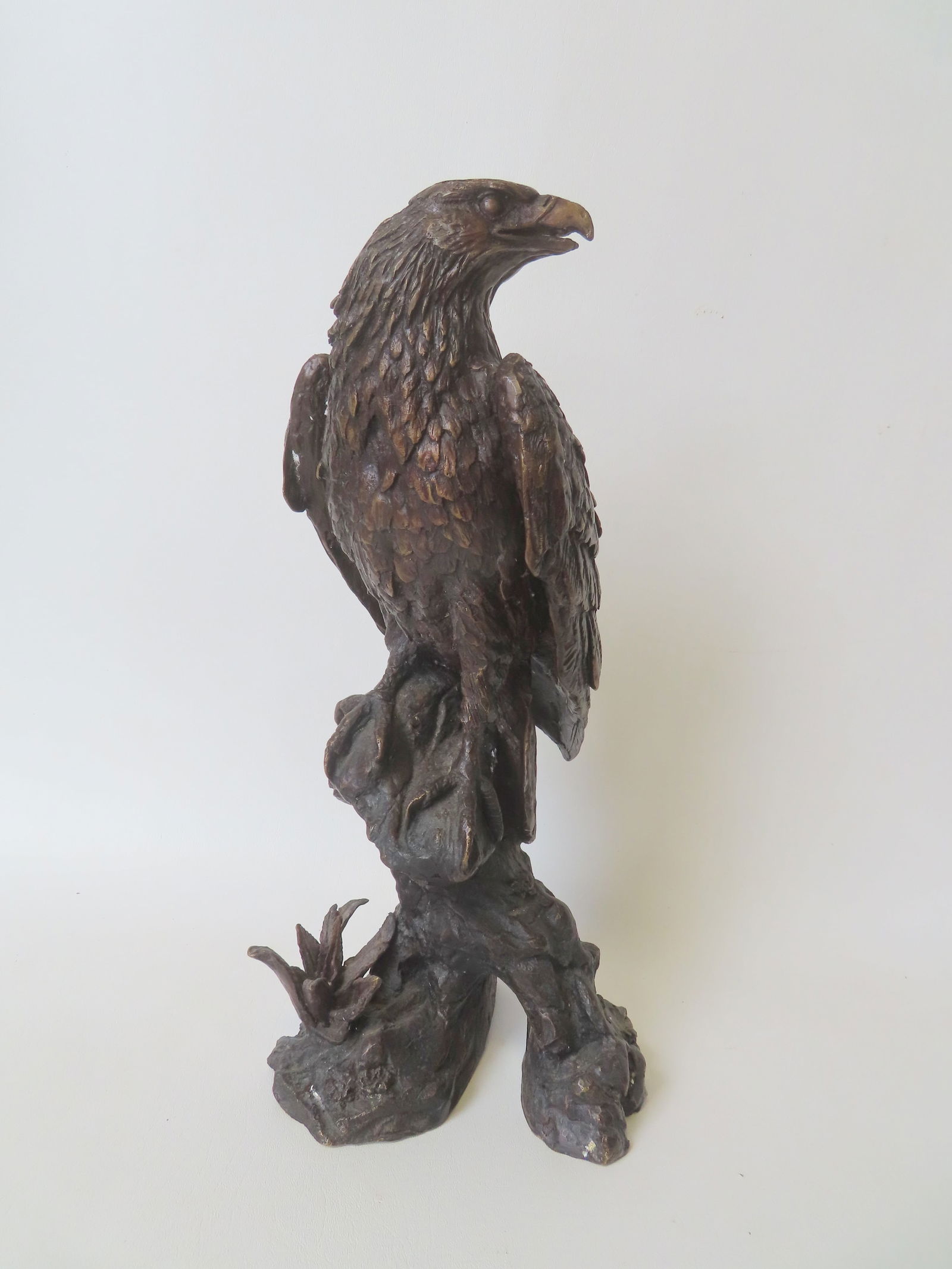 An unsigned bronze sculpture depicting an eagle standing on stump, showing good detail. Very good: An unsigned bronze sculpture depicting an eagle standing on stump, showing good detail. Very good condition. Measures 16"H x 7 1/2"W. Provenance: From the Marni Bakst and William Sadler collection of