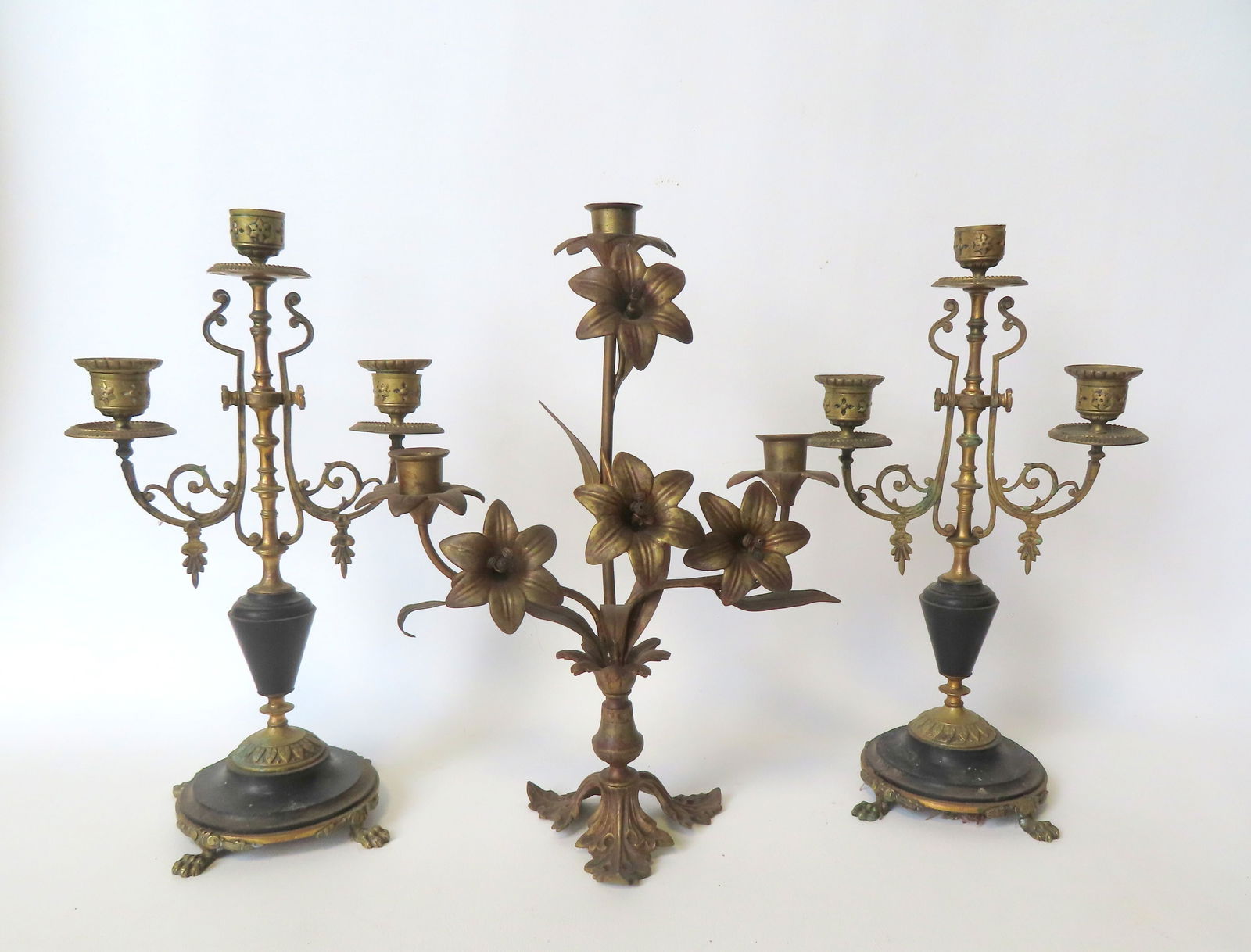 Three French candelabras. The first, a matched pair in bronze and black marble with 3 fonts and claw: Three French candelabras. The first, a matched pair in bronze and black marble with 3 fonts and claw feet - each 14 1/2"H x 6 1/2" diameter at base; the second a single brass or bronze candelabra havi