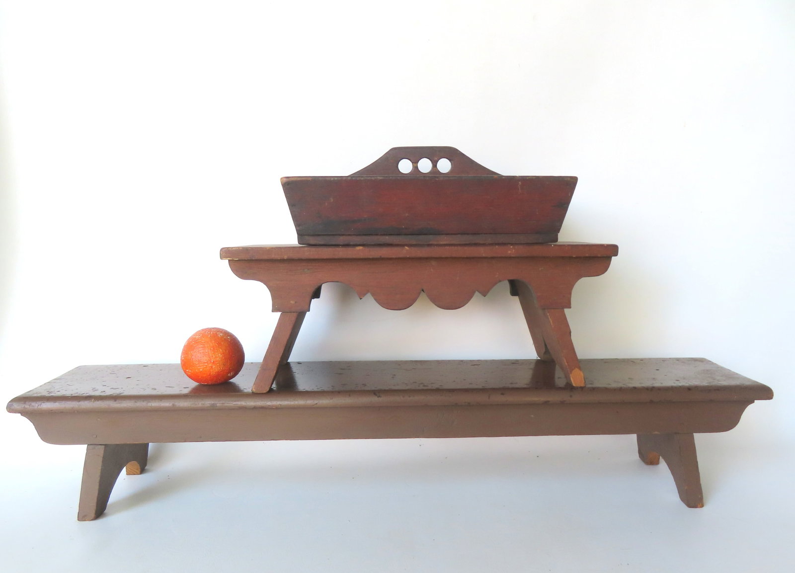 Three 19th century country items, including: A kneeling bench with canted and 1/2 moon cutouts on: Three 19th century country items, including: A kneeling bench with canted and 1/2 moon cutouts on ends in old brown paint; a cricket stool with a very fine shaped apron, and cutout and canted sides; a