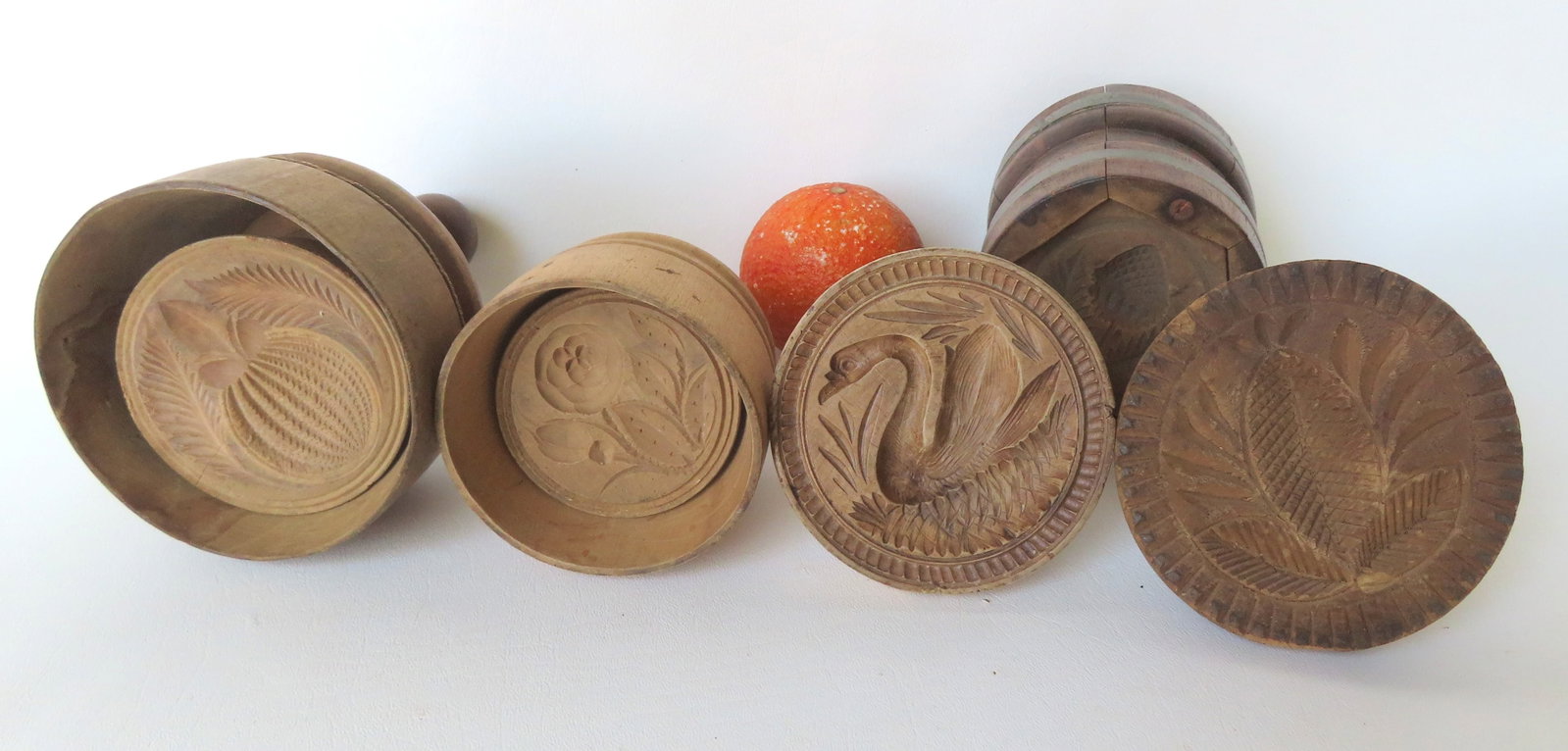 Grouping of 5 early wooden butter stamps including swan, pineapple, flower, vegetable, and: Grouping of 5 early wooden butter stamps including swan, pineapple, flower, vegetable, and strawberry, all 19th century. The largest 4 1/2" diameter x 6 1/2" H. Good condition. Provenance: From a priv
