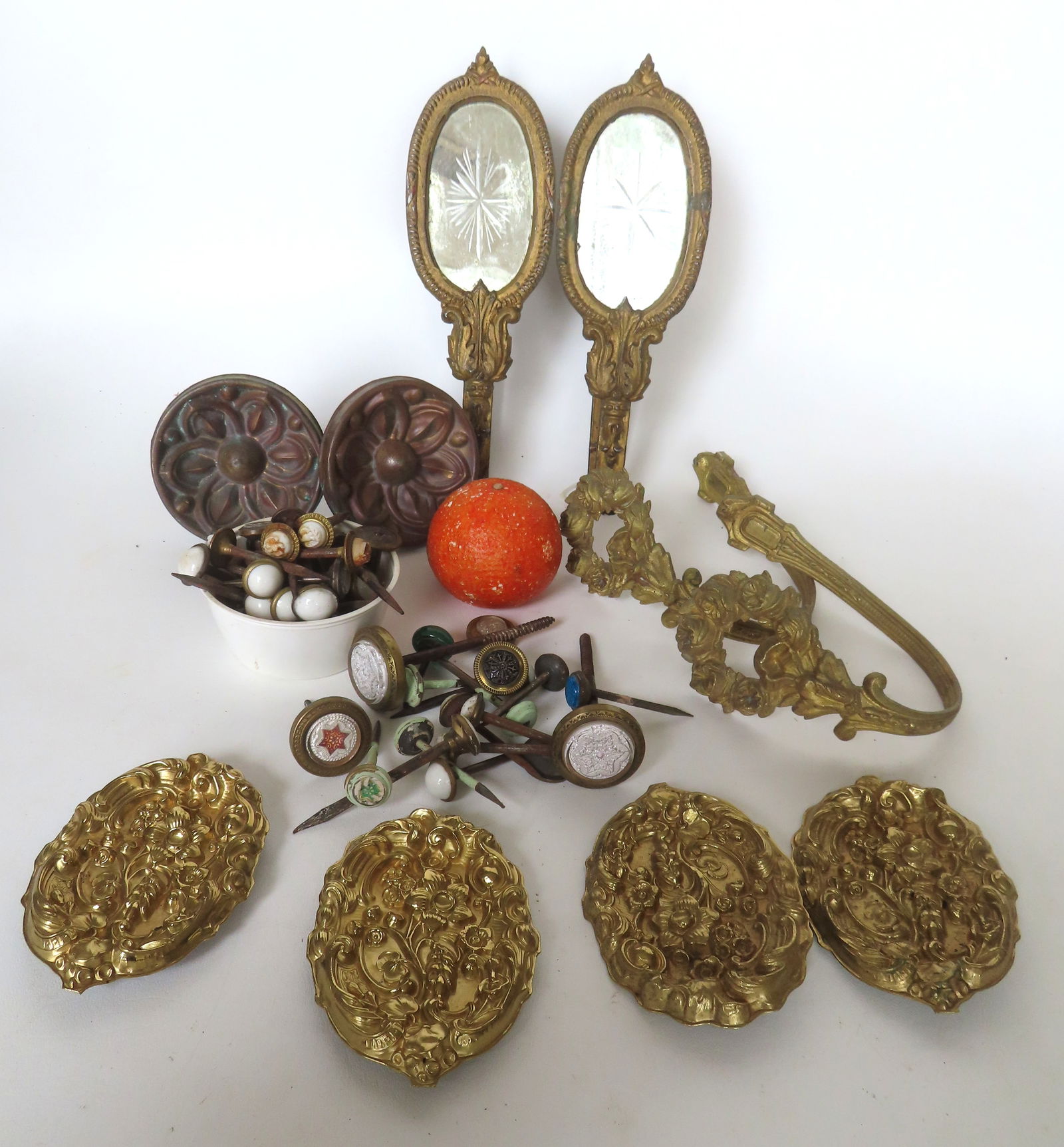 Large grouping of 19th century tie backs including: The largest are 2 gilded tin framed cut mirrors: Large grouping of 19th century tie backs including: The largest are 2 gilded tin framed cut mirrors and measure 3 5/8"W x 4"D x 10 1/2"L; 4 smaller nail shaped with cut stone images of spread wing eag