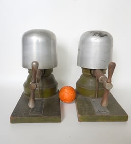 Two mechanical hand crank hat stretchers, both signed Garve, early 20th century. Each approximately
