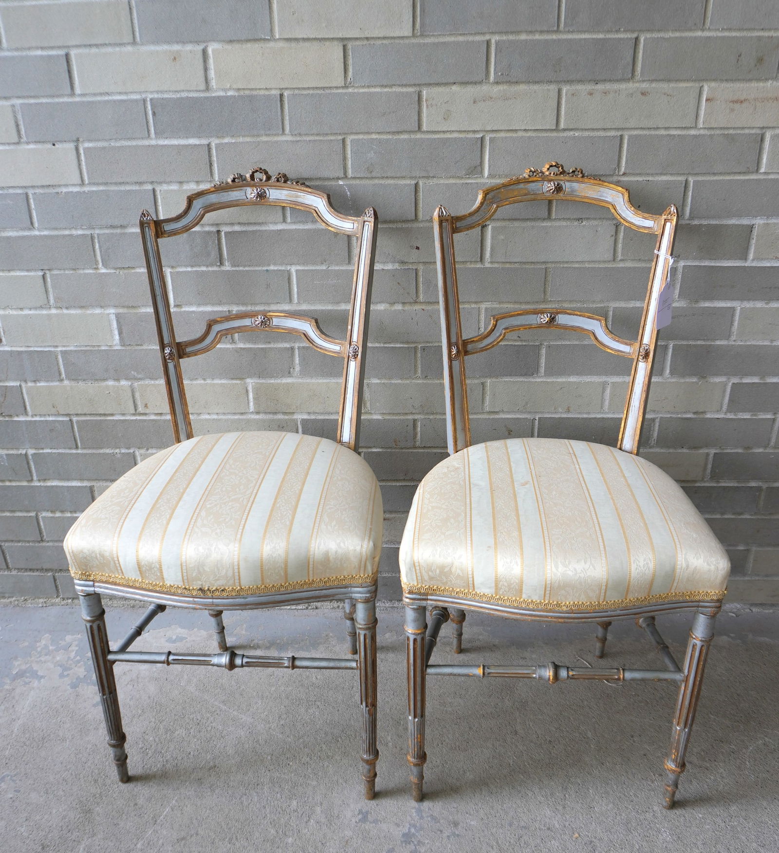 Two French ballroom side chairs, hand carved with fluted legs and cross stretchers in original: Two French ballroom side chairs, hand carved with fluted legs and cross stretchers in original blue-gray paint, mid 19th century or earlier with newer professionally covered seats (several small stain