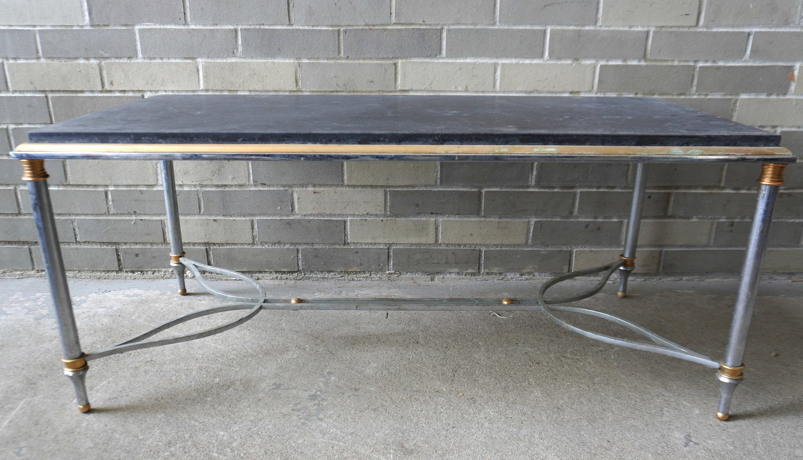 A mid-century high quality polished steel and brass coffee table with slate top, 1950-70. Some: A mid-century high quality polished steel and brass coffee table with slate top, 1950-70. Some surface scratches to top, and some surface rust to nickel plating, otherwise very good condition. Measure