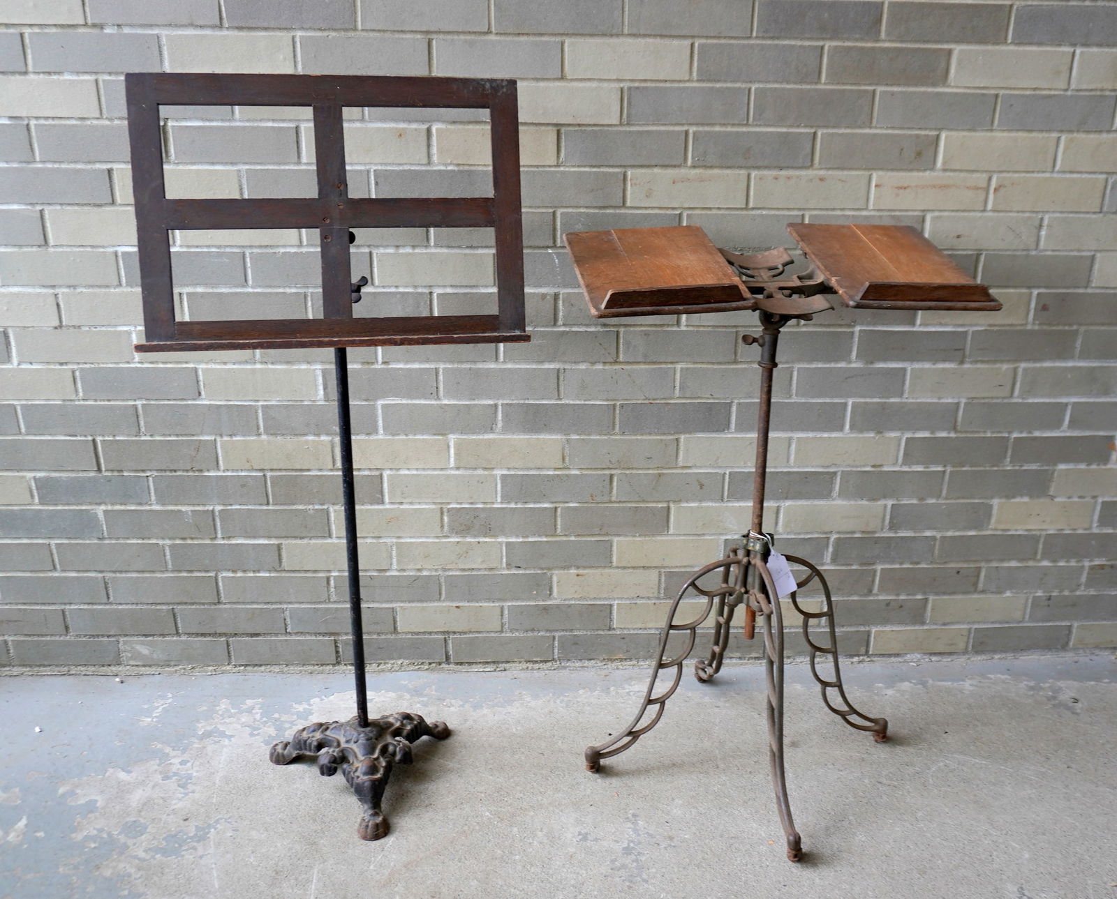 An oak adjustable floor standing book holder & music stand with iron supports. The largest 20"W x: An oak adjustable floor standing book holder & music stand with iron supports. The largest 20"W x 43"H. Both in good condition, late 19th to early 20th century. Provenance: From the Marni Bakst and Wi