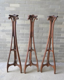 A grouping of 3 matching Masonic Art Nouveau style oak floor standing torchieres each with a single
