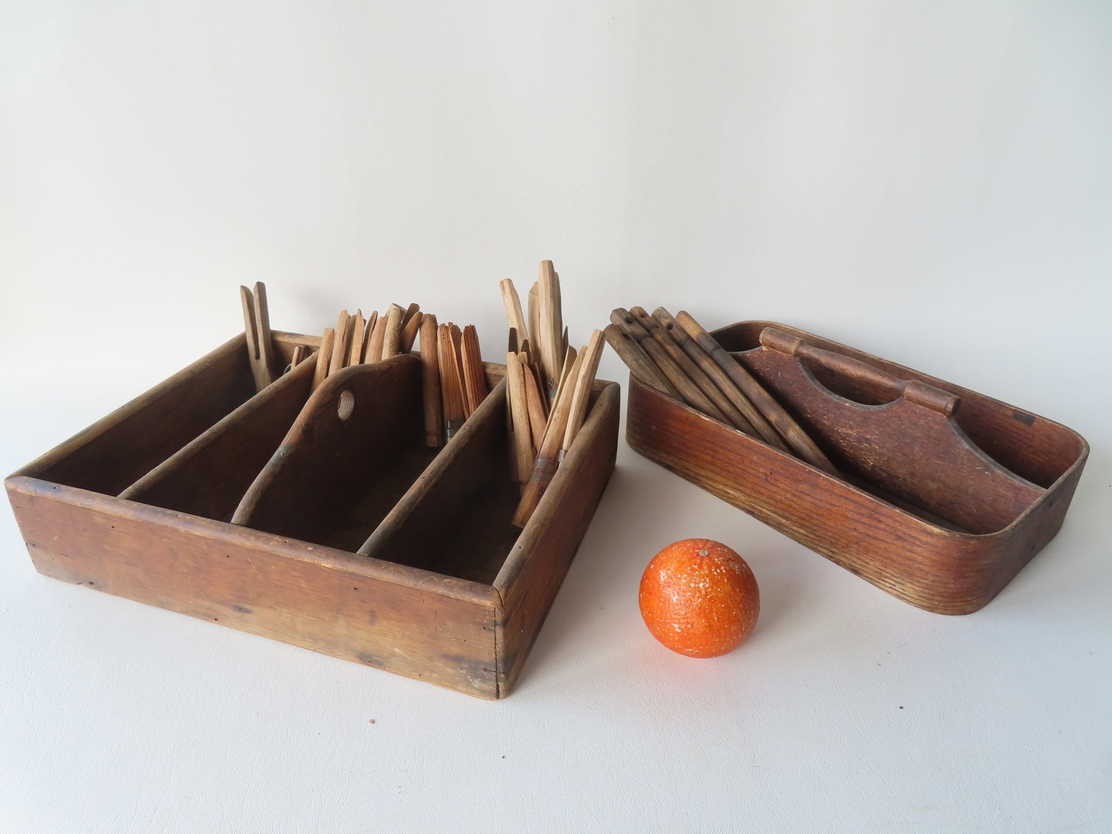 A grouping of country collectibles including: 2 cutlery boxes - the largest 14 1/2"L x 11"D x 4: A grouping of country collectibles including: 2 cutlery boxes - the largest 14 1/2"L x 11"D x 4 3/4"H; 6 hand made wooden spikes/pins; and 20 hand made clothes pins. All 19th century and in good condi