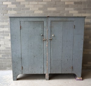 An unusual 2 part side by side cupboard, with each part having 1 door with 1 paneled side. Layers of