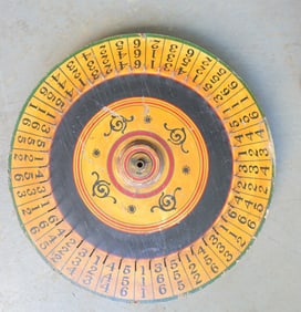 A vintage hand made double sided carnival gaming wheel in original paint, early to mid 20th century.