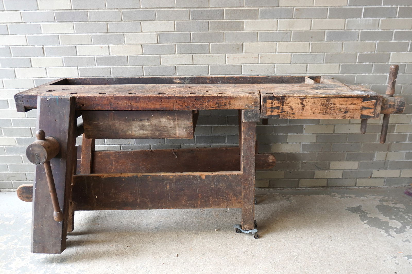 A large 19th century carpenter's maple work bench with 2 vises and lower drawer, dovetailed: A large 19th century carpenter's maple work bench with 2 vises and lower drawer, dovetailed construction. The top lifts off so it can be easier to transport. Measures 78"L x 24 1/4"D x 31 1/2"H. Exten