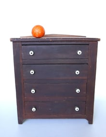 A miniature 3 drawer chest with porcelain pulls, short backsplash and cutout base - original