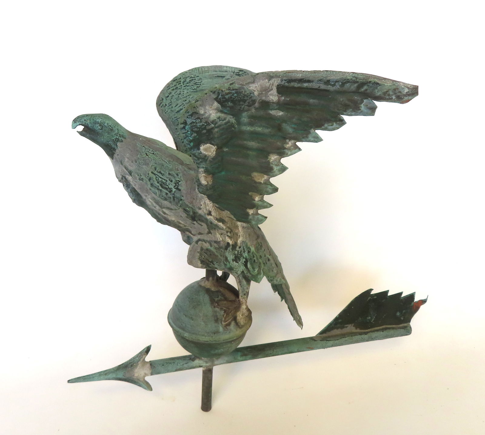 A small size full body copper spread wing eagle copper weathervane with excellent patina, circa: A small size full body copper spread wing eagle copper weathervane with excellent patina, circa 1900. The eagle, standing or orb, is mounted on arrow. Missing the lower feather on directional arrow, s