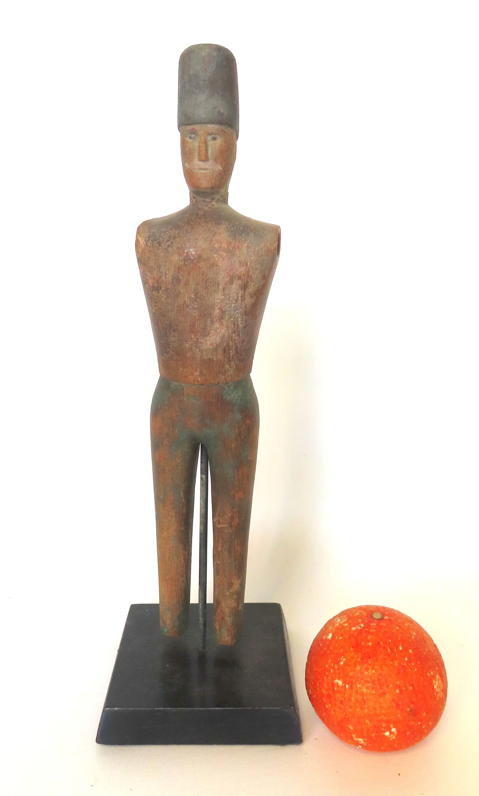 A folk art Hessian soldier whirligig fragment missing arms and feet otherwise good condition and: A folk art Hessian soldier whirligig fragment missing arms and feet otherwise good condition and mounted on a wooden museum display stand. Traces of original paint. Mid 19th century. Measures 14 1/4"H