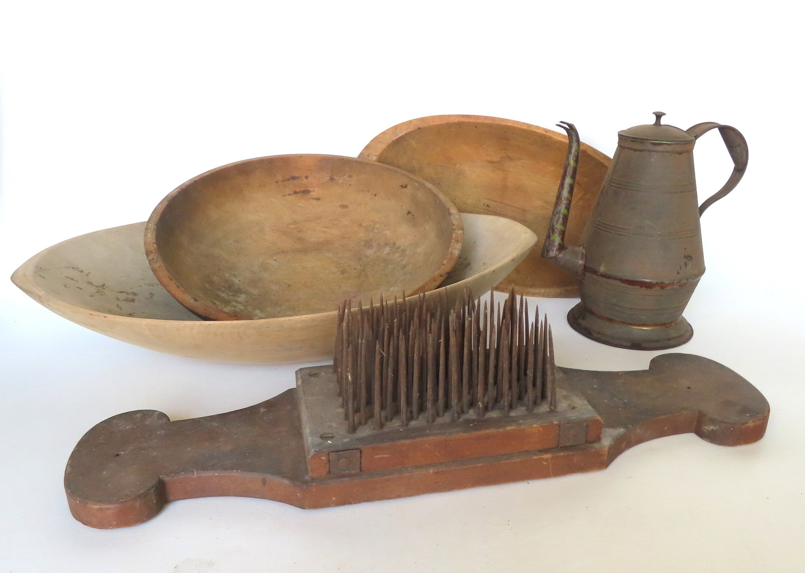 Grouping of 5 country items, 19th century, including 3 treenware bowls - the largest 24 1/2"L x 15"W: Grouping of 5 country items, 19th century, including 3 treenware bowls - the largest 24 1/2"L x 15"W x 5"H - all in good condition; a Pennsylvania toleware coffee pot - most of original paint is missi