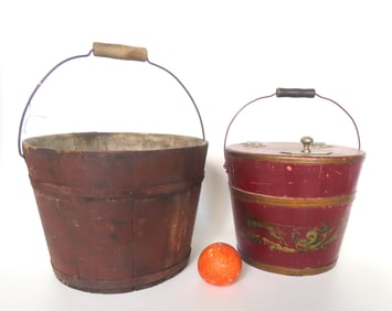 Two early wooden buckets with bale handles, including: Shaker staved bucket in original red stain
