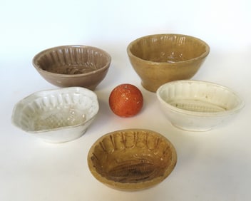 Grouping of 5 jello or pudding molds, 2 in yellowware and 3 in ironstone, all 19th century and in