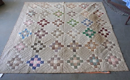 A very fine early patchwork quilt in the 12 Patch Square Block pattern with a triangular border, all