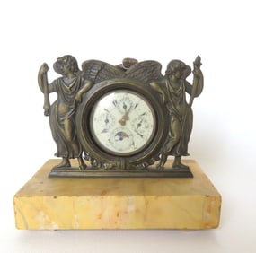A chronometer pocket watch and an ornate bronze watch holder mounted on marble base. The holder is