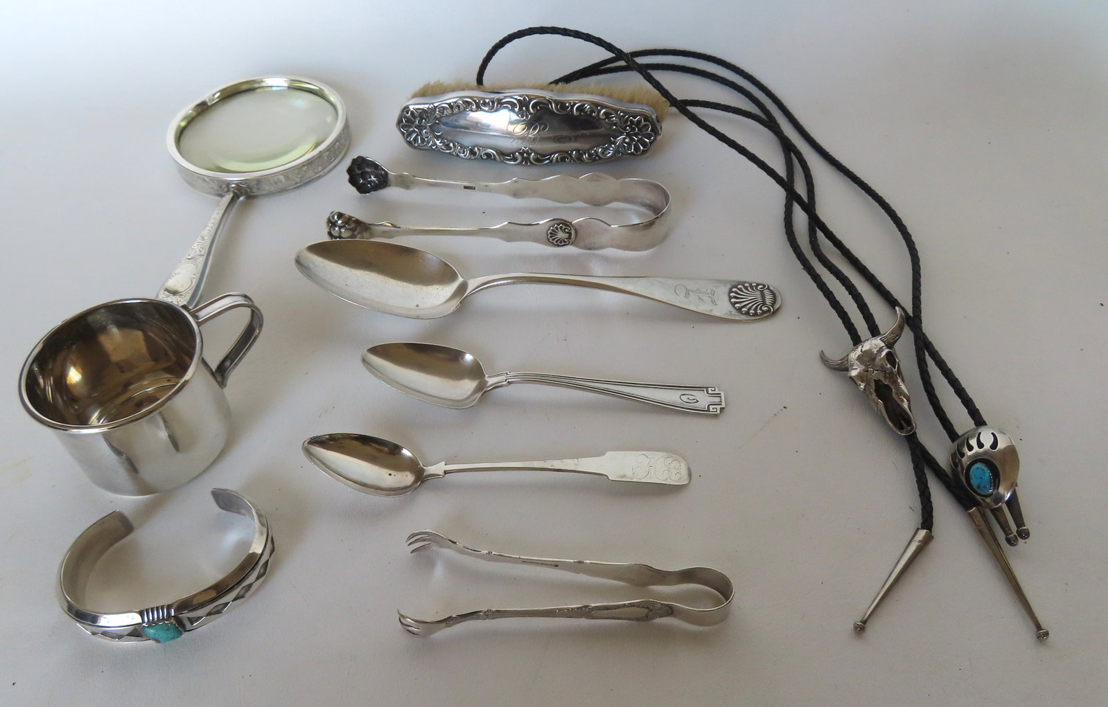 Lot of Sterling and coin silver collectibles including: Coin silver tongs and spoon - weighs 1.7: Lot of Sterling and coin silver collectibles including: Coin silver tongs and spoon - weighs 1.7 troy oz, magnifying glass with sterling frame and handle, 2 Mexican silver bolos (probably sterling but