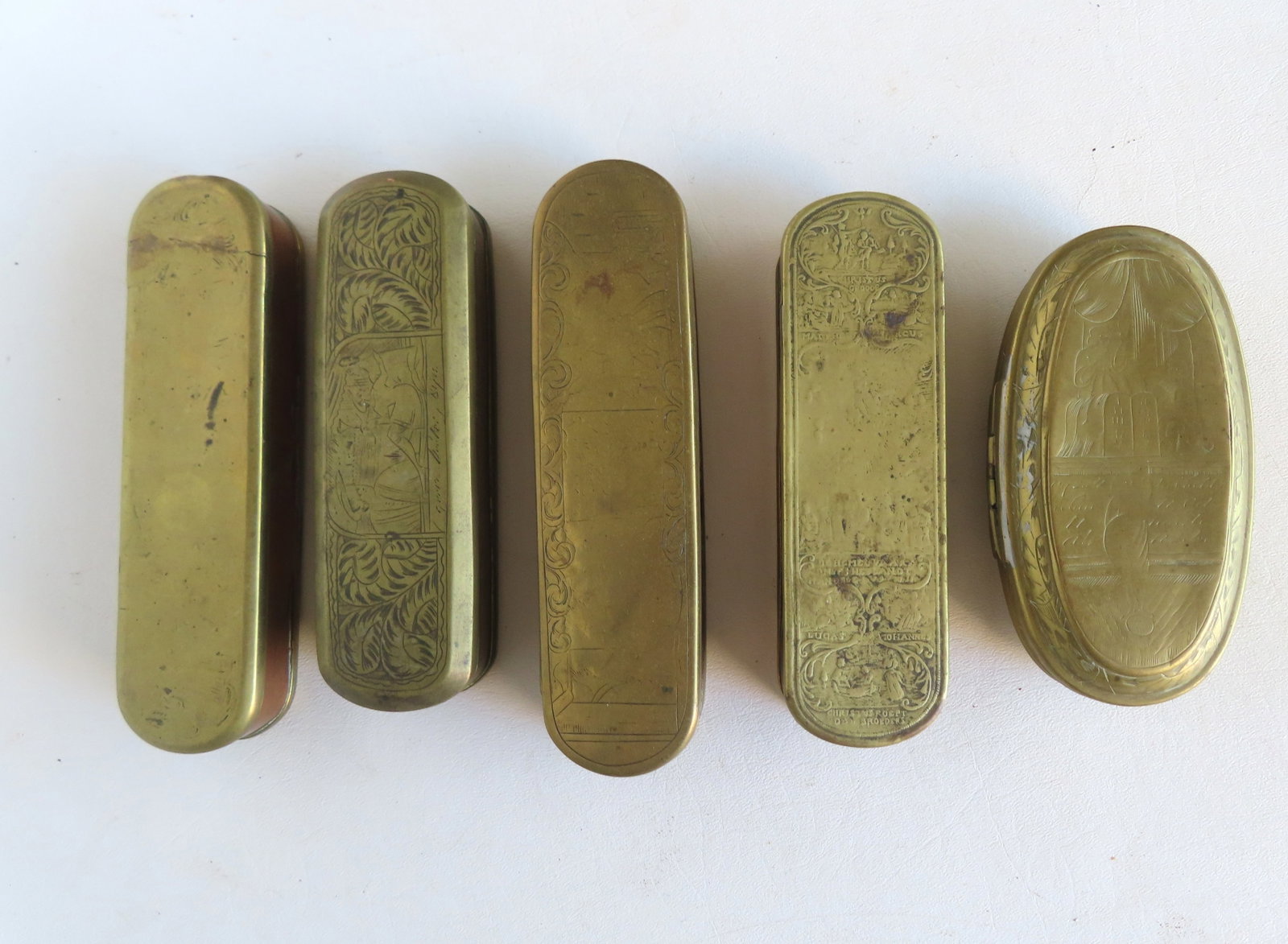 Grouping of 6 early brass tobacco boxes, all believed to be Dutch, 18th century. Some wear to the: Grouping of 6 early brass tobacco boxes, all believed to be Dutch, 18th century. Some wear to the engravings, otherwise all are in good condition. Note attached to the smaller oval box by Rev. Alfred 