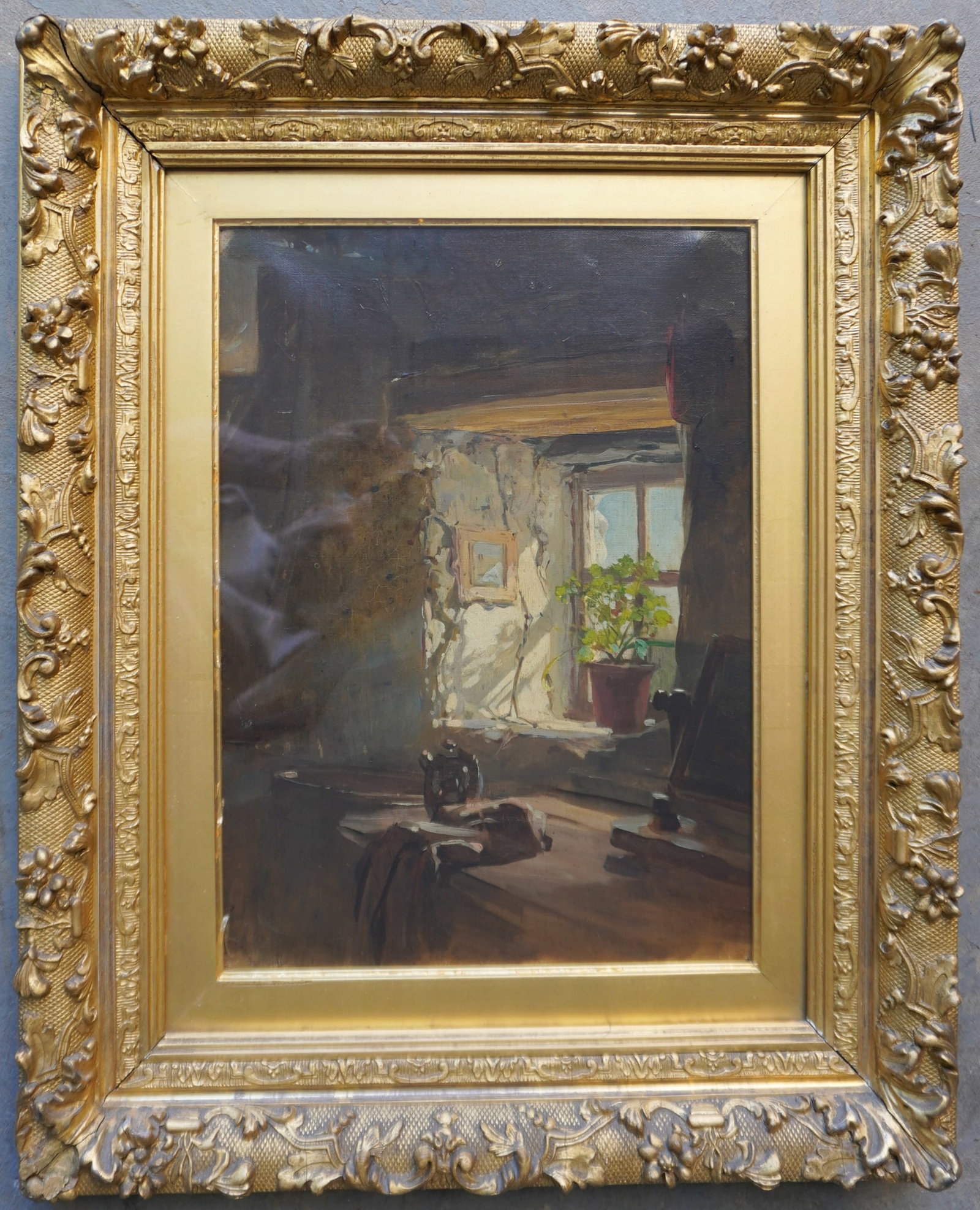 O/C Interior house scene with light shining through window with potted plant on window sill, 19th: O/C Interior house scene with light shining through window with potted plant on window sill, 19th century. Housed in it's original gilt gesso frame - both the frame and the artwork in very good condit