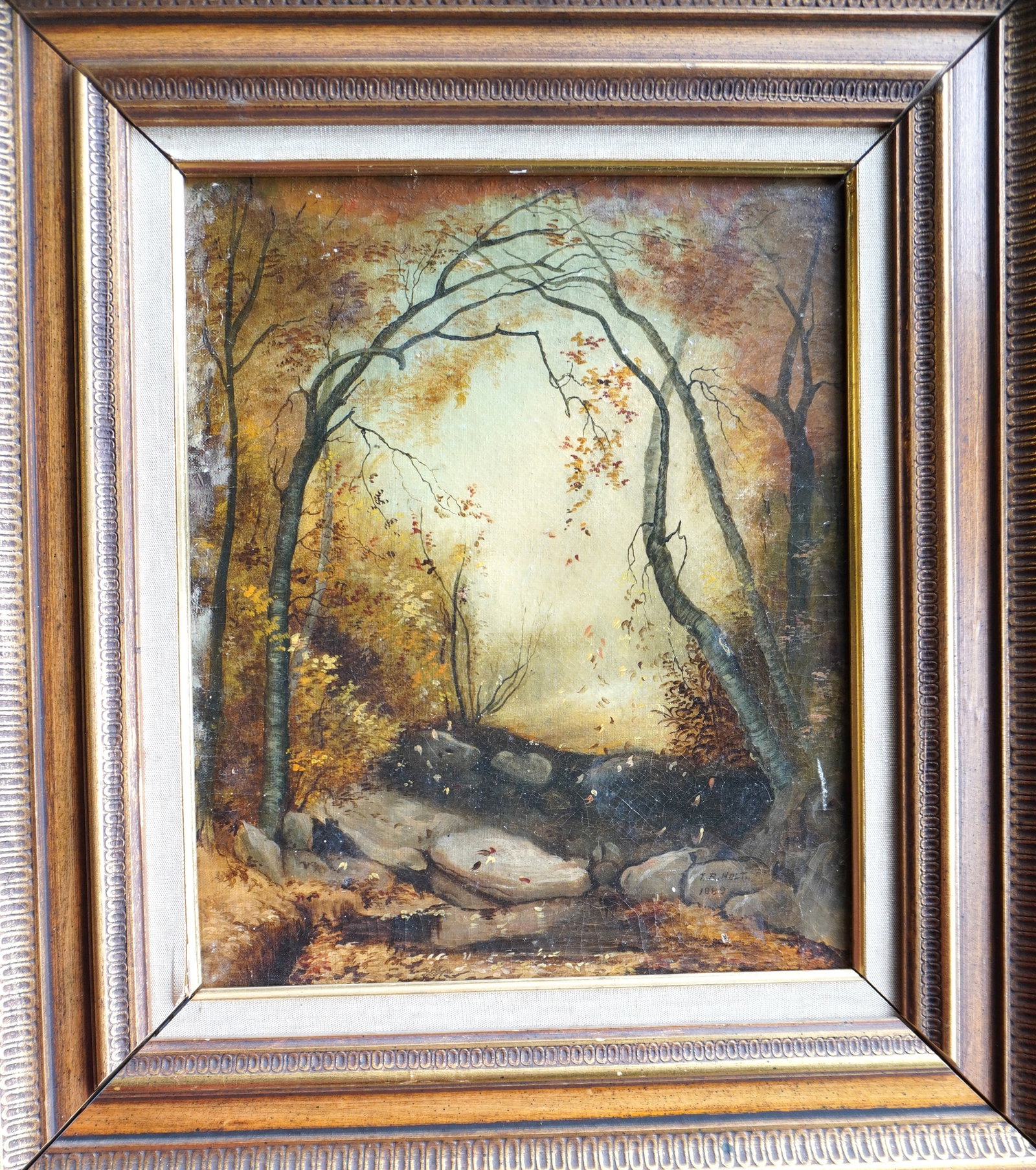 O/C Country landscape with leaves falling from trees, signed "T.R. Holt 1889". Housed in a 20th: O/C Country landscape with leaves falling from trees, signed "T.R. Holt 1889". Housed in a 20th century frame - a tiny blemish in canvas hardly noticeable, else very good condition. Stretcher size 10"