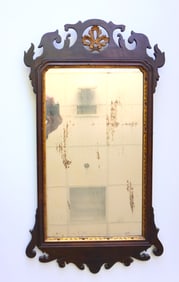 A Chippendale mahogany wall mirror with pierced gilded leaf medallion in center of crest, and having