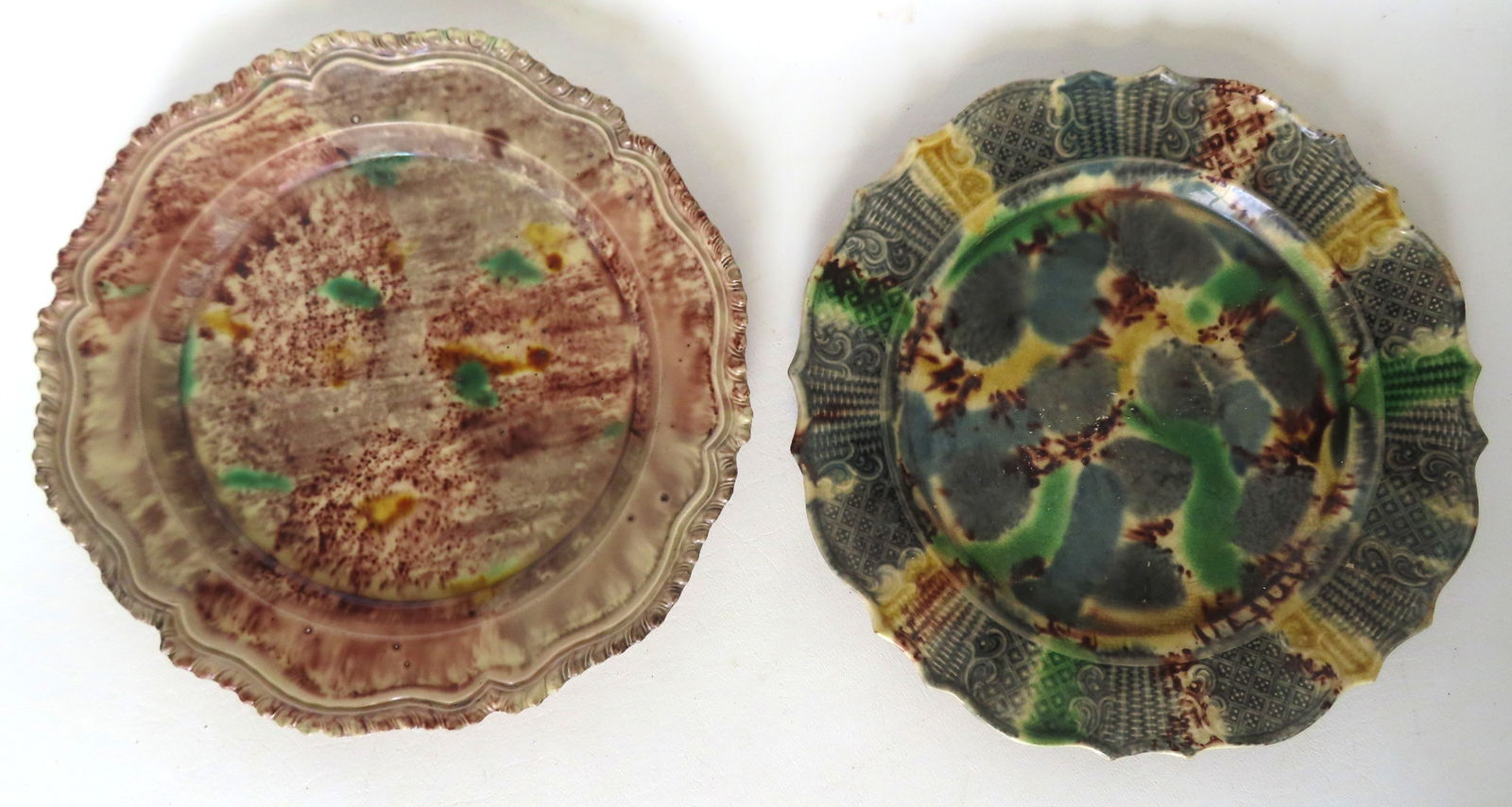 Two English Whieldon Ware plates, both believed to be circa 1760-80; one with glazing bubbles in: Two English Whieldon Ware plates, both believed to be circa 1760-80; one with glazing bubbles in surface glazing and measures 9 1/4" diameter; the other with scalloped edge measures 9 1/2" diameter. O