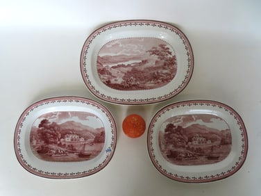 Three Staffordshire transferware platters, all with the same pink luster borders - some use wear but