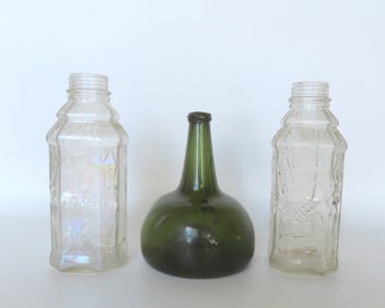 Grouping of 3 vintage bottles. The first, an 18th century hand blown onion bottle in dark green with