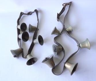 Two complete sets of brass sleigh bells with original leather straps, both holding 6 bells - both