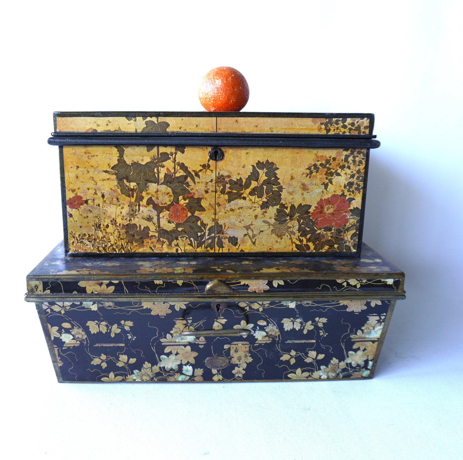Two 19th century sheet iron traveling lock boxes with double handles, with later decorative vinyl: Two 19th century sheet iron traveling lock boxes with double handles, with later decorative vinyl coverings. Both with locks but lacking keys, otherwise good condition. The largest measures 18 1/4"W x