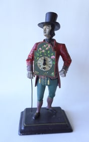 The Peddler clock, a hand painted cast metal novelty clock in the form of a clock peddler standing
