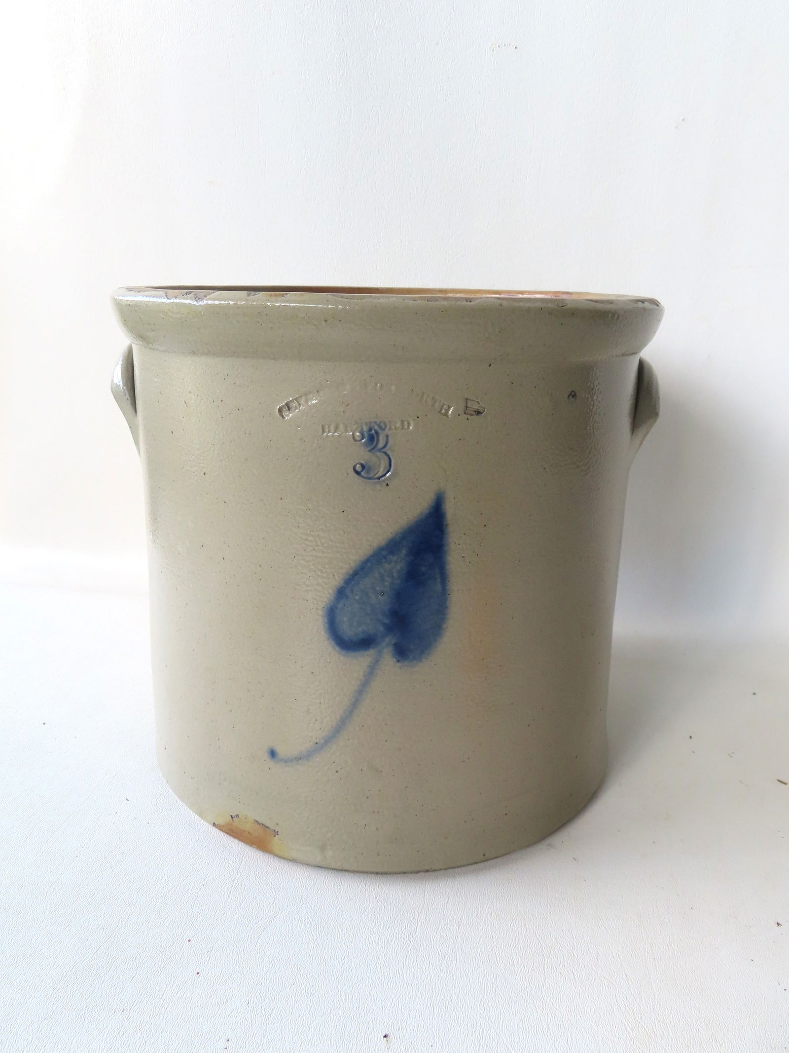 Stoneware crock, 3 gallon, with the impressed mark of "Seymour & Bosworth / Hartford", and decorated: Stoneware crock, 3 gallon, with the impressed mark of "Seymour & Bosworth / Hartford", and decorated with a cobalt blue leaf - measures 10 1/2" diameter x 10 1/2"H. Very good condition, no damage. Pro