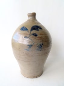 A NY stoneware jug decorated with an incised flower with brushed blue over what appears to be a blue
