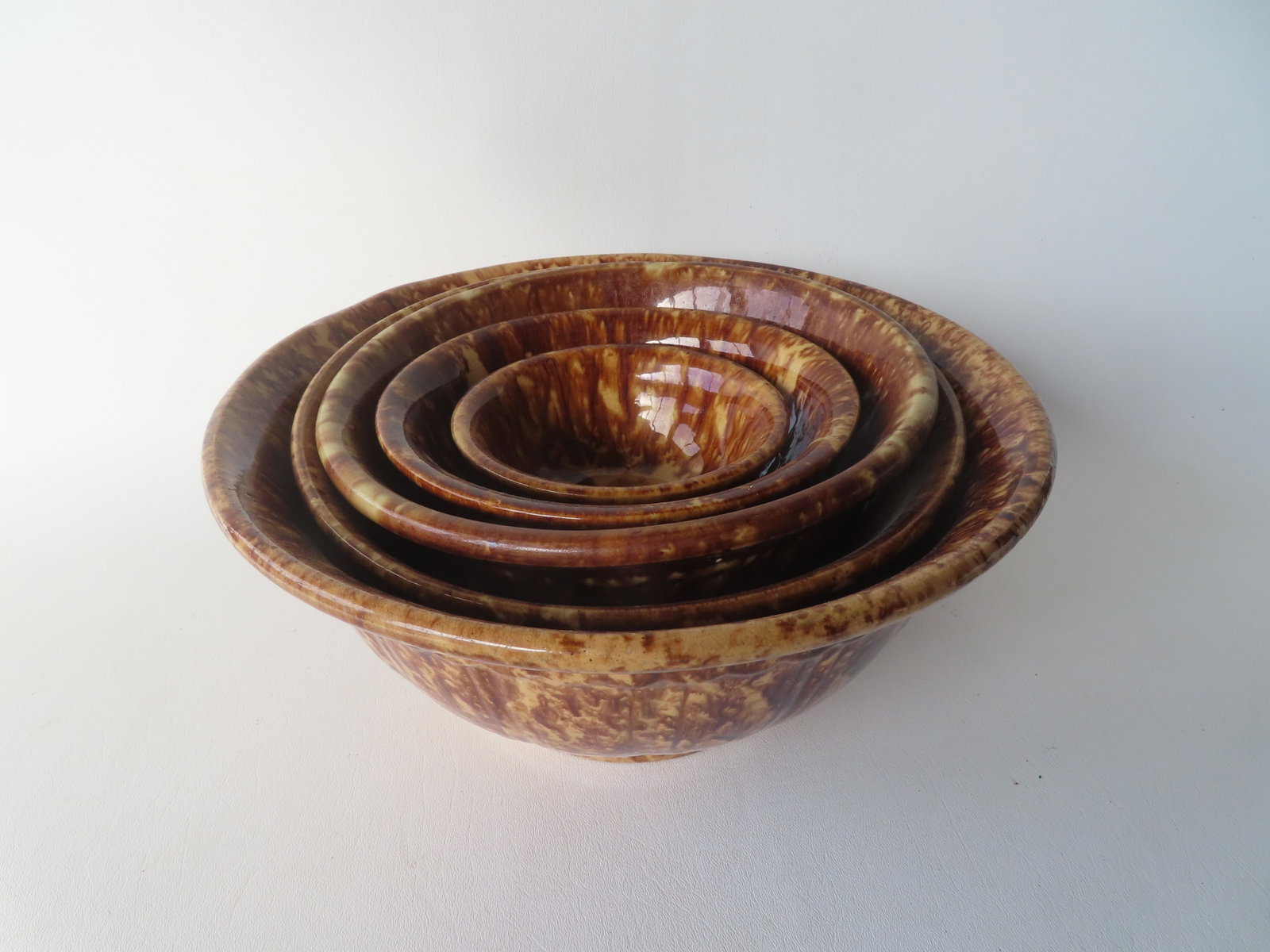An assembled set of 5 nesting Bennington mixing bowls, ranging in size from 2 1/4"H x 5 1/4": An assembled set of 5 nesting Bennington mixing bowls, ranging in size from 2 1/4"H x 5 1/4" diameter to 5 1/2"H x 12 1/4' diameter. All in very good condition without damage. Provenance: From a priva