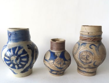 Three Westerwald small bulbous stoneware tankards, all lacking lids, 18th/19th century. The first