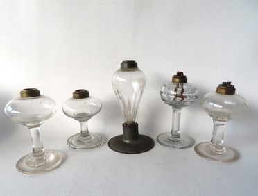 Five whale oil lamps, all hand blown, late 18th to early 19th century. The largest mounted on tin