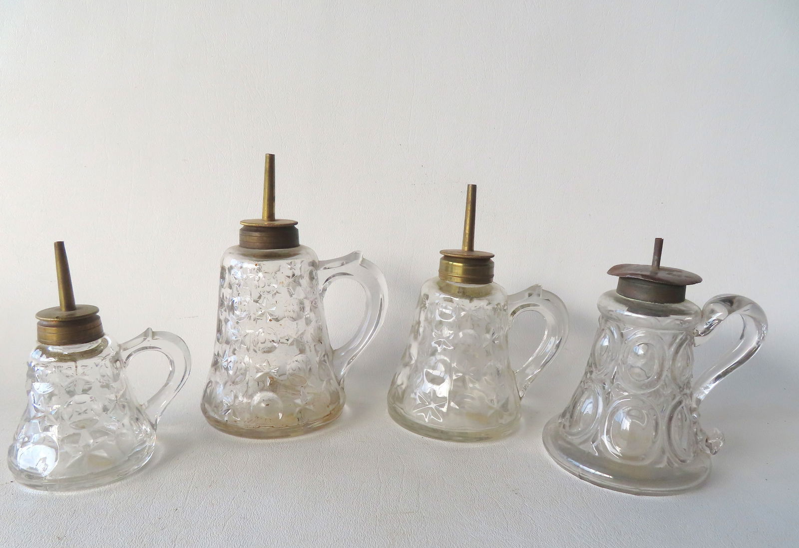 Four glass fluid lamps, 3 hand blown in the Star and Moon pattern, 19th century. All in very good: Four glass fluid lamps, 3 hand blown in the Star and Moon pattern, 19th century. All in very good condition. The largest 5 3/4"H.