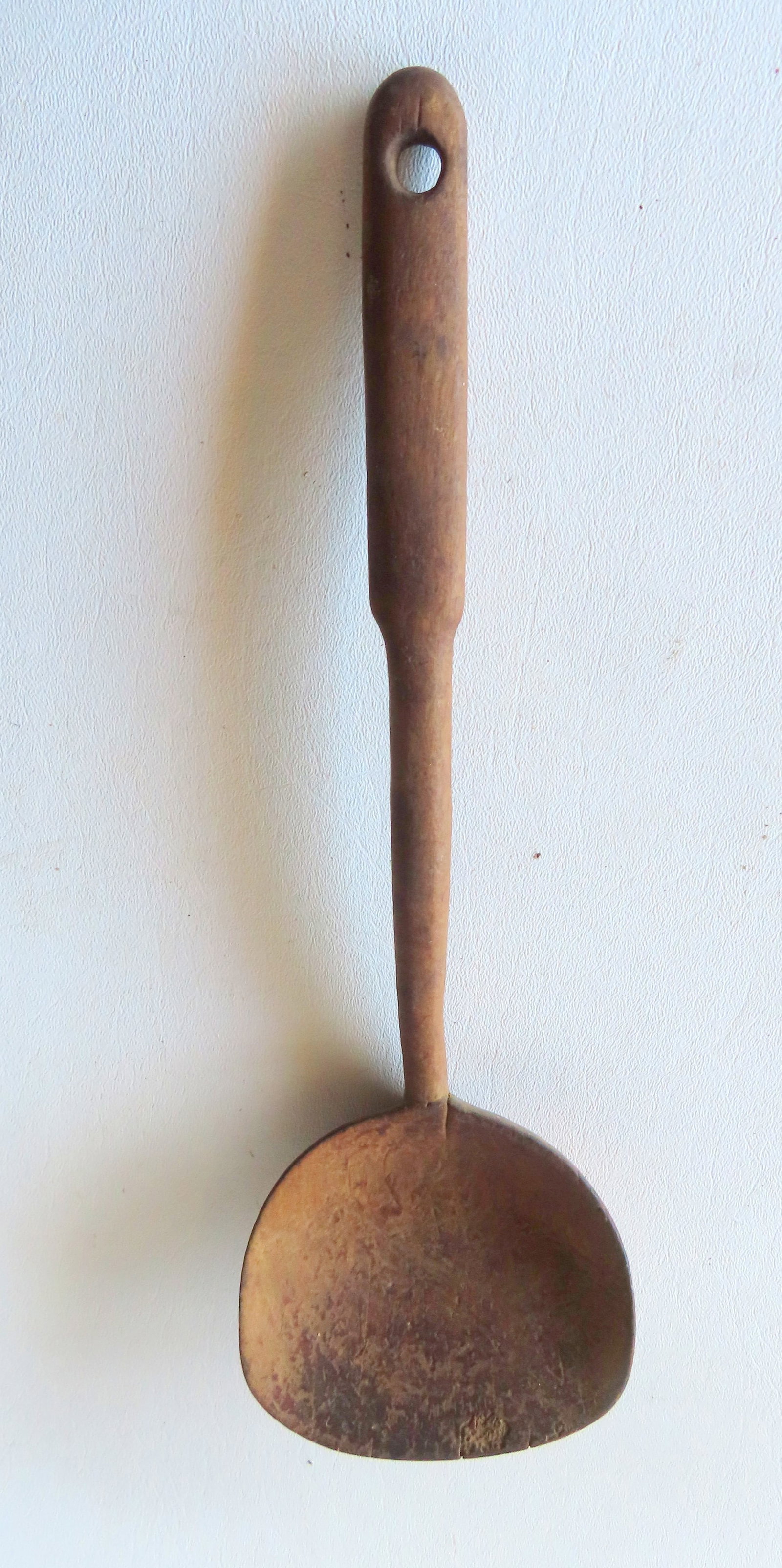A very primitive hand made wooden ladle, with traces of original paint - use wear consistent with: A very primitive hand made wooden ladle, with traces of original paint - use wear consistent with age, likely late 18th century, otherwise good condition. Measures 14"L.