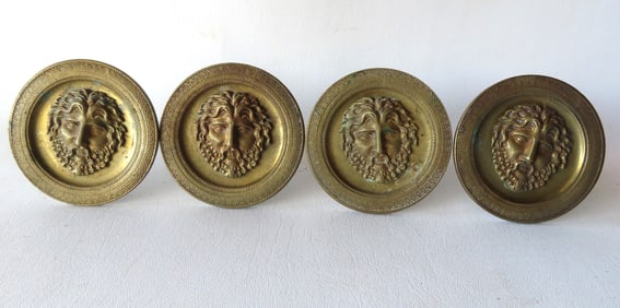 Grouping of 4 matching French bronze curtain tie-backs decorated with a raised portrait of Bacchus -