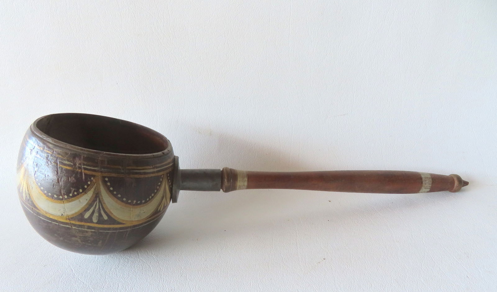A very fine American sailor made coconut shell dipper decorated with swags and tassels, all in: A very fine American sailor made coconut shell dipper decorated with swags and tassels, all in original paint with pewter mount, early 19th century - measures 14 1/4"L x 4"W. Age check down side, othe