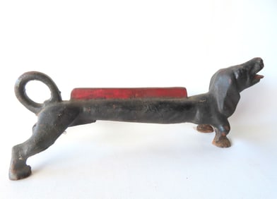 A solid cast iron Dachshund boot scraper in original black and red paint, early 20th century - good