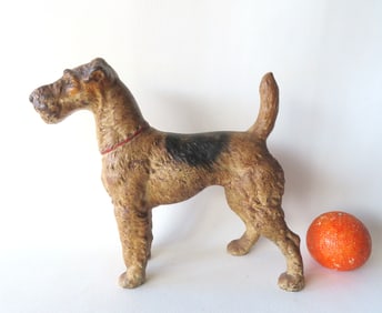 A vintage large size Wire Haired Fox Terrier cast iron door stop in original paint with hand painted