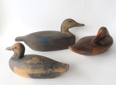 Grouping of 3 carved wooden decoys including: A sleeping mallard decoy with tooled beak and in very