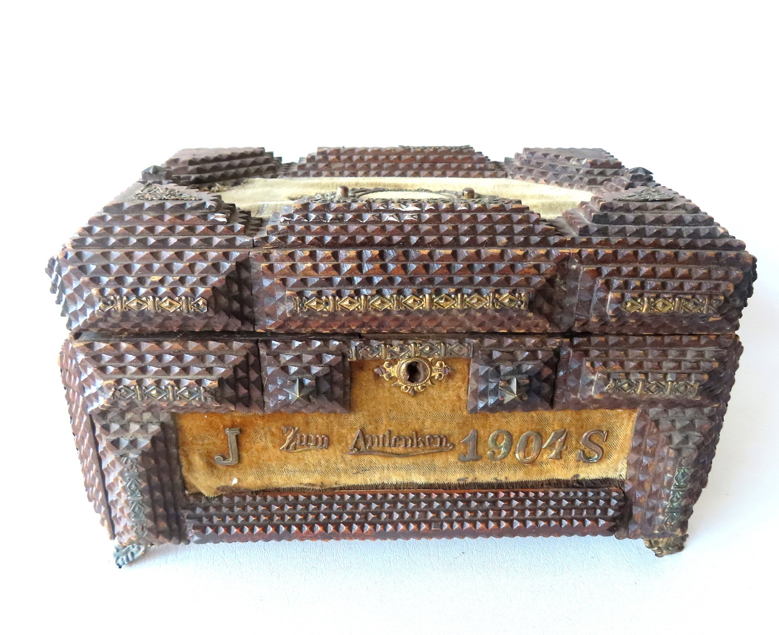 A German tramp art lady's box marked across the front "J Zum Andenken 1904 S" - applied grass: A German tramp art lady's box marked across the front "J Zum Andenken 1904 S" - applied grass ornamentation but missing some pieces including a lion's head handle and corner ornaments to lid, also mis
